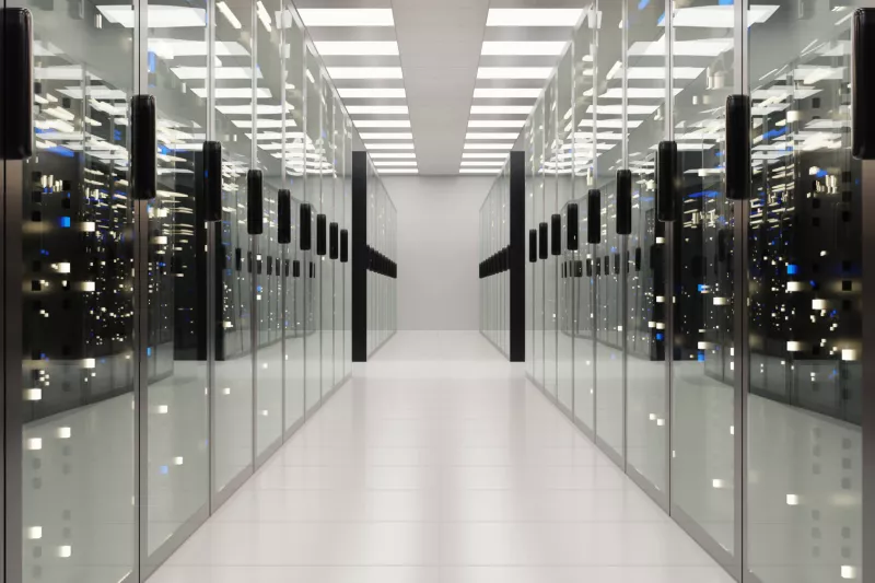 a long corridor with servers behind glass doors