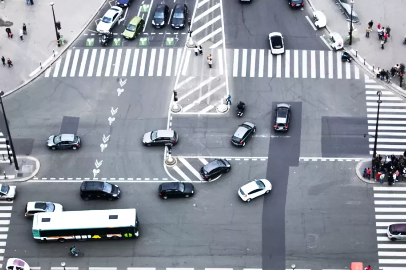 Smart traffic management at a busy urban intersection with cars, buses, cyclists, and pedestrians — showcasing the importance of intelligent traffic monitoring, intersection safety, and real-time video analytics for modern cities.