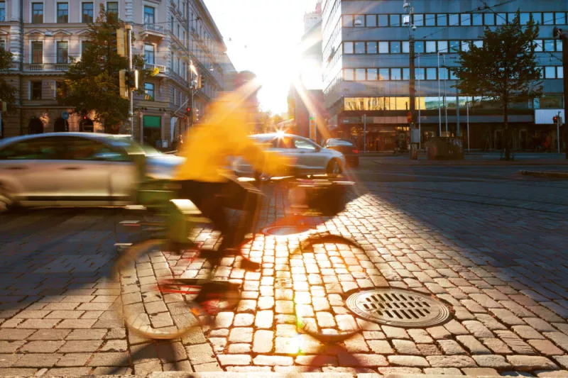 Intelligent traffic monitoring at a city intersection with cyclists and vehicles, showcasing smart data collection, road safety, and traffic efficiency for modern urban mobility solutions.