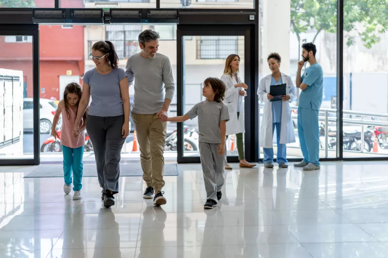 Family in hospital lobby entrance 