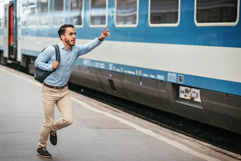 man running after train