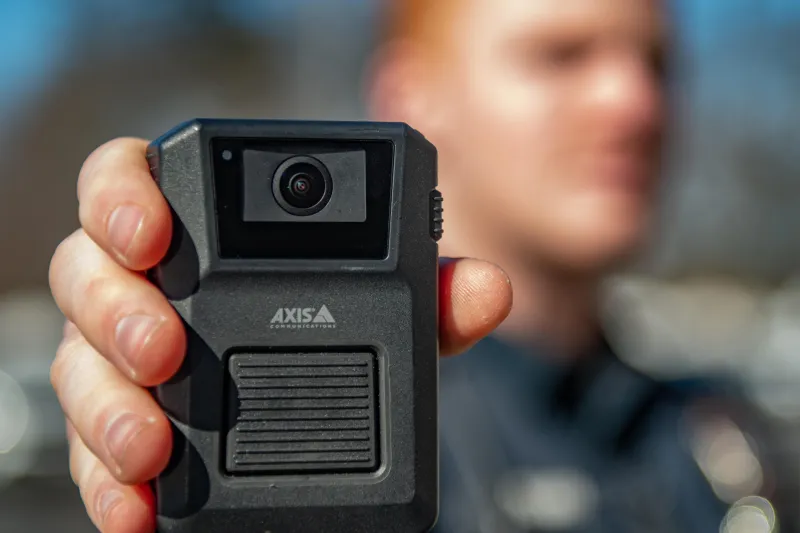 Axis body worn camera held out by officer