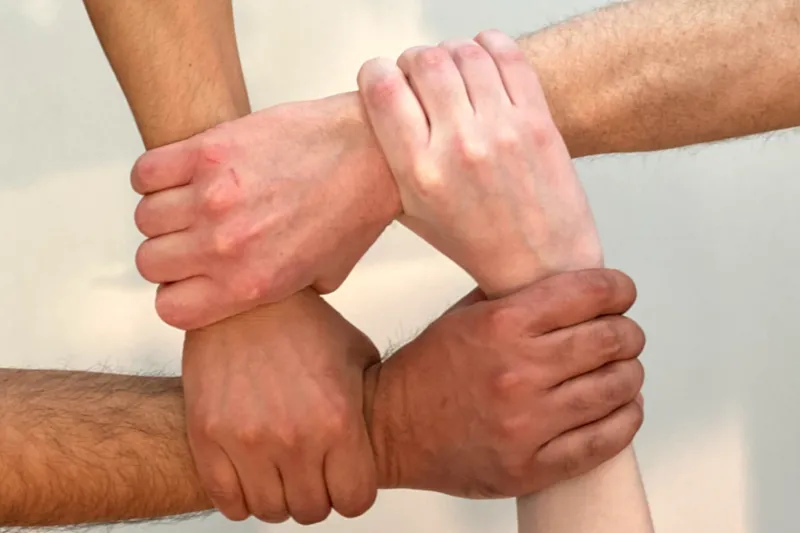 Hands connecting in a square