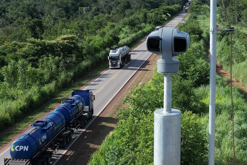 Aerial shot of camera along highway with traffic on road