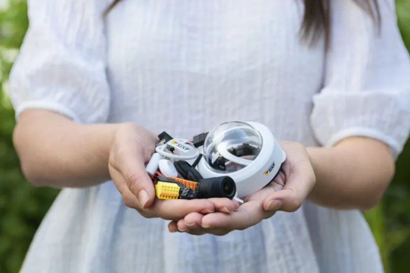 person holding camera parts