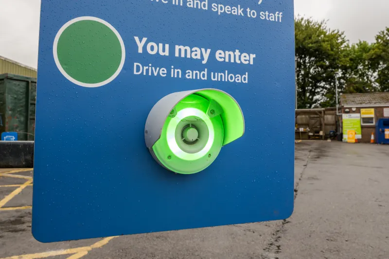Green light signal on a Dorset recycling centre entry sign reading 'you may enter'