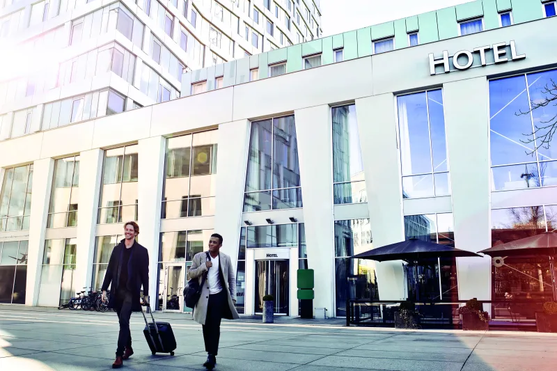 Two guests arriving at hotel with luggage