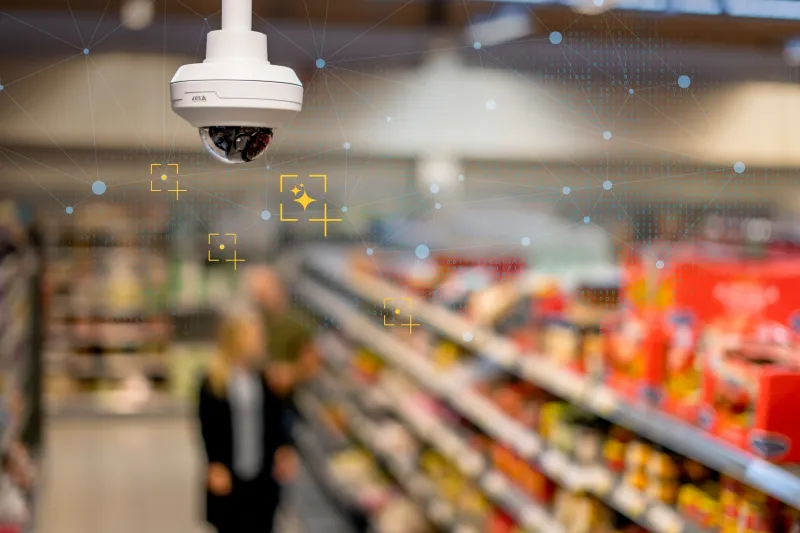 An Axis camera mounted on the ceiling to surveil a grocery store.