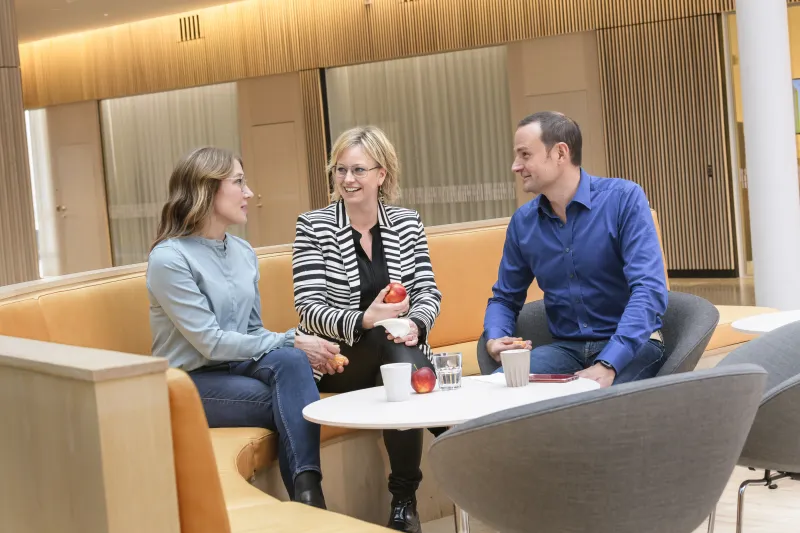 group of colleagues talking in lounge area