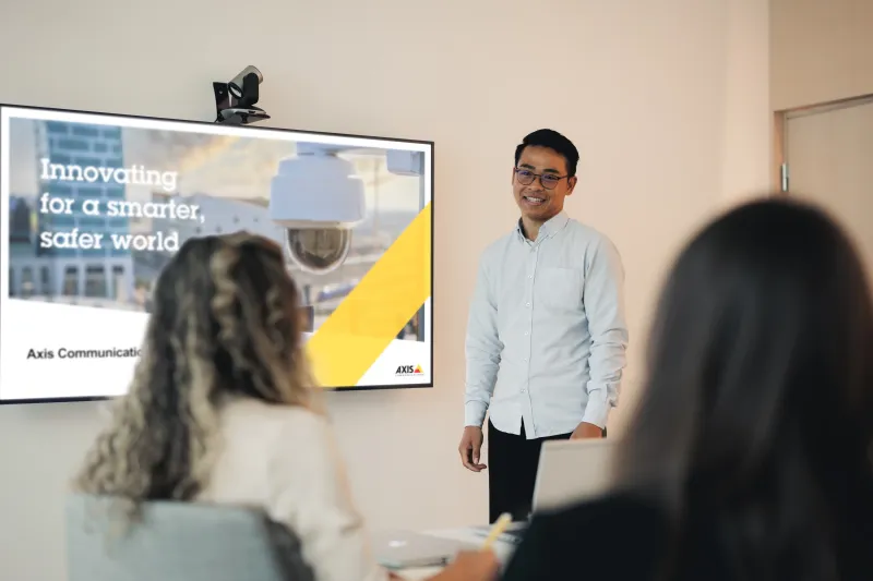Axis employee presenting to a group in a conference room at Axis Communications.