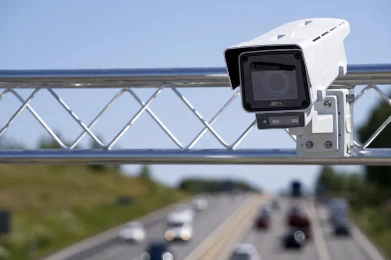 AXIS Q1656-LE mounted on a highway overpass to monitor the traffic.