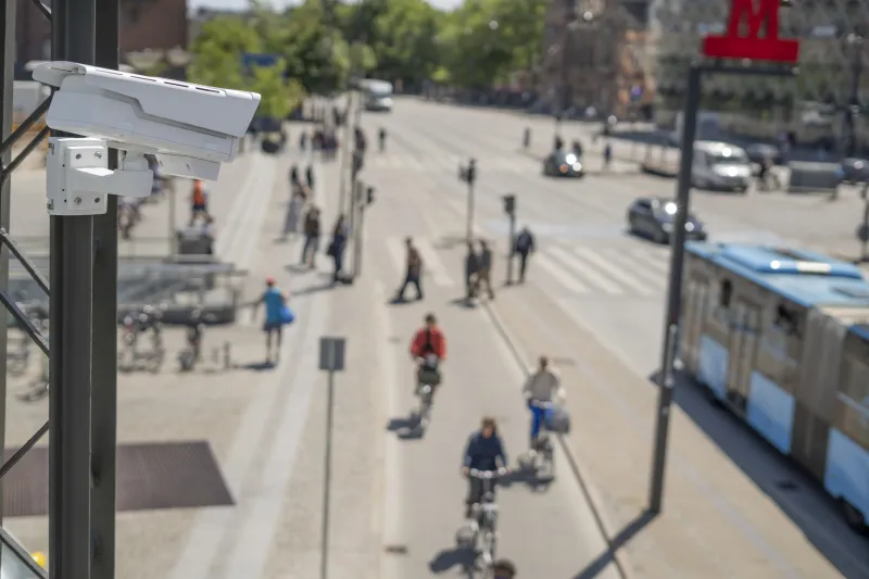 Busy urban intersection with pedestrians, bicycles and vehicles.