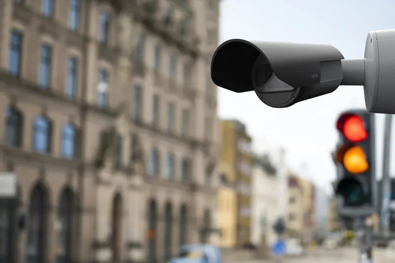 AXIS Q1800-LE License Plate Camera placed high up close to a traffic light.