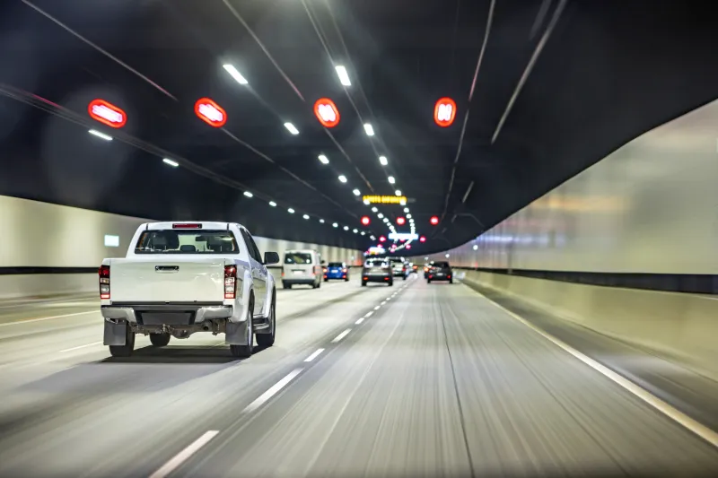 High speed cars driving in a highway tunnel.