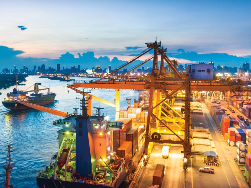 Axis IP Camera is packed with built-in analytics to alert you when needed. The camera is viewing a cargo ship harbor in sunset