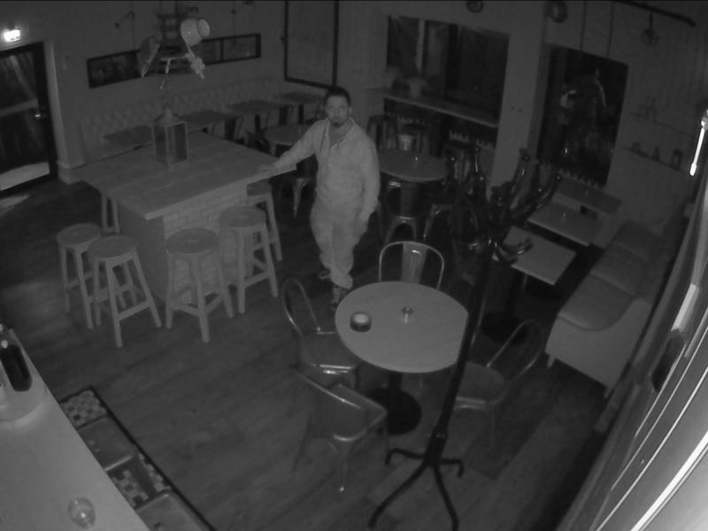 A man in a coffee shop in the dark