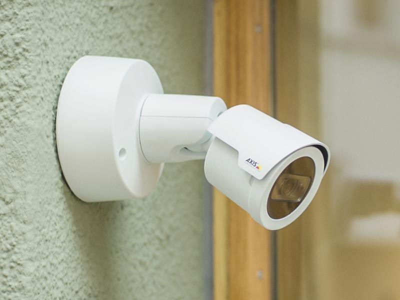 IP Camera viewed from its right angle on a green facade. 