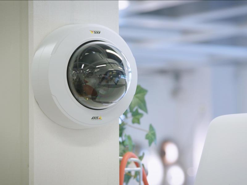Axis IP Camera has Varifocal lens with remote zoom and focus. The camera is viewed from a indoor retail store.