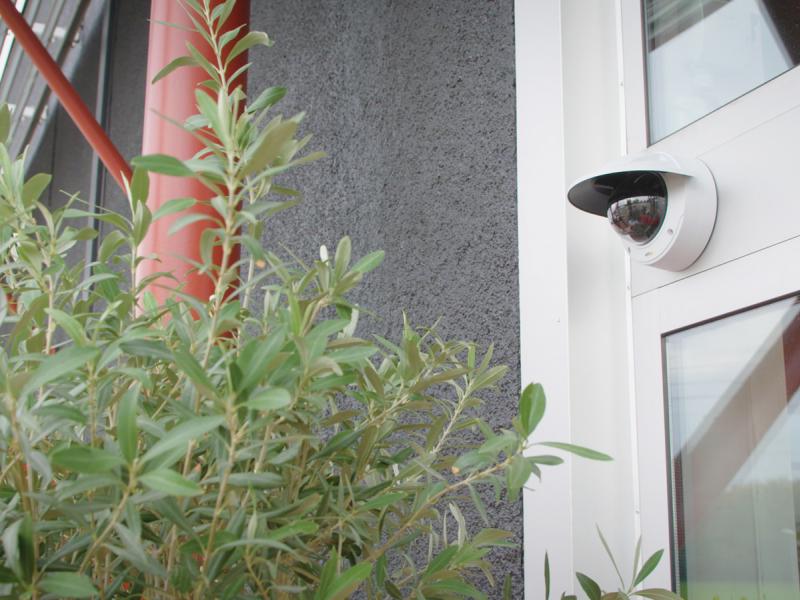 Axis IP Camera has Signed firmware and secure boot. The camera is viewed outside on a mall.