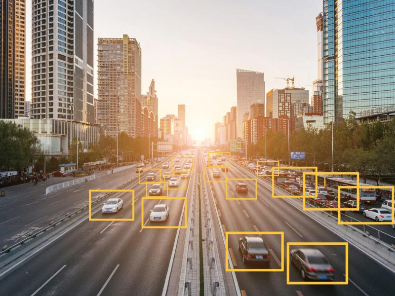 Traffic in the city. Some vehicles are marked with yellow boxes.