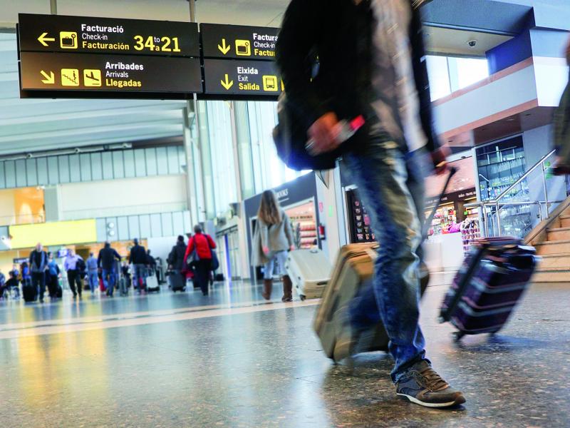 Axis IP Camera - Airport passengers walking with carryon luggage