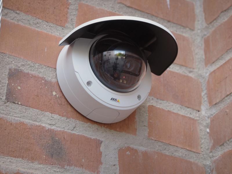 Axis IP camera mounted on a brick wall