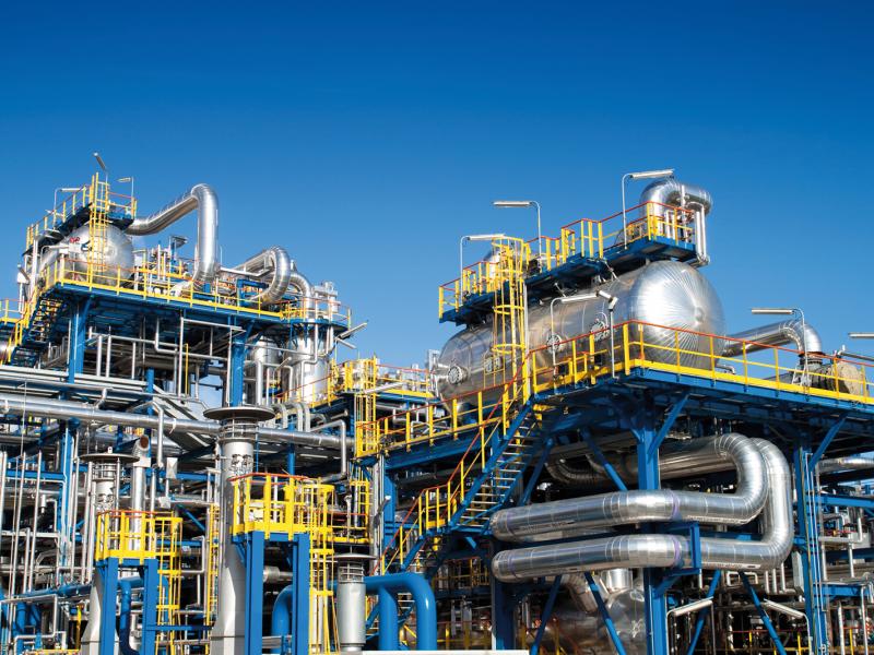 Oil refinery plant with blue sky in the background.