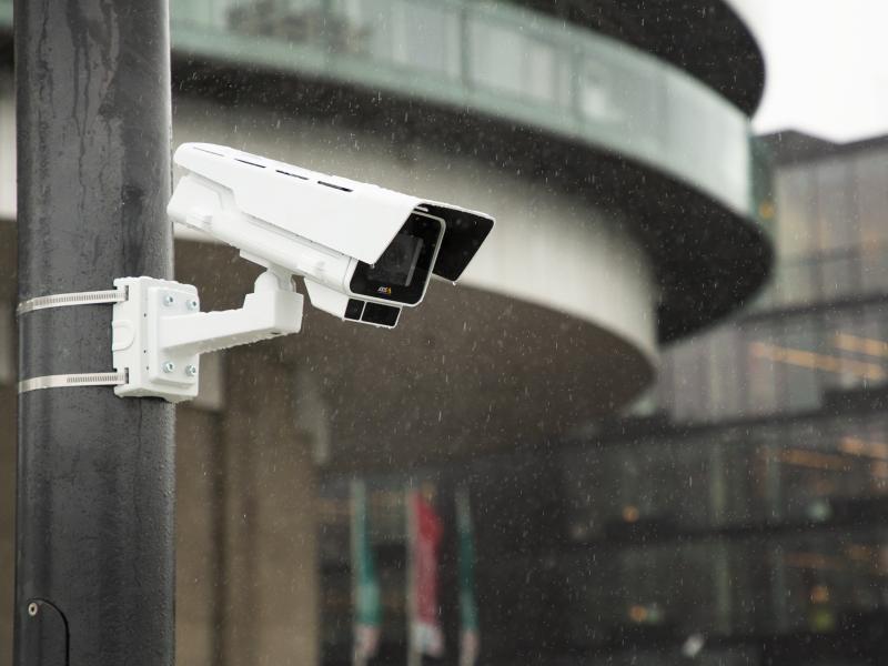 AXIS P1377-LE and P1378-LE mounted on a pole in an outdoor environment.