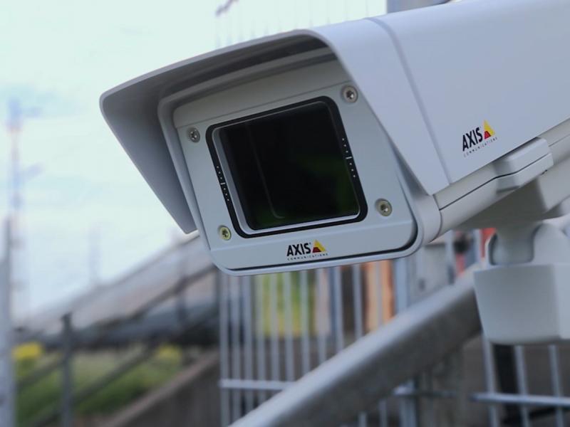 AXIS Q1615-E Mk II mounted in outdoor environment. A train passing by in the background.