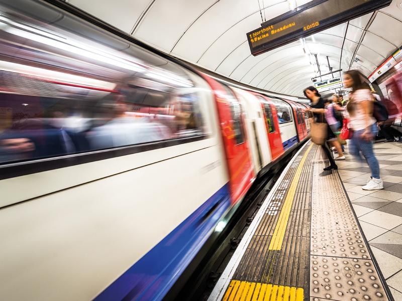 People standing by a subway platform in London.