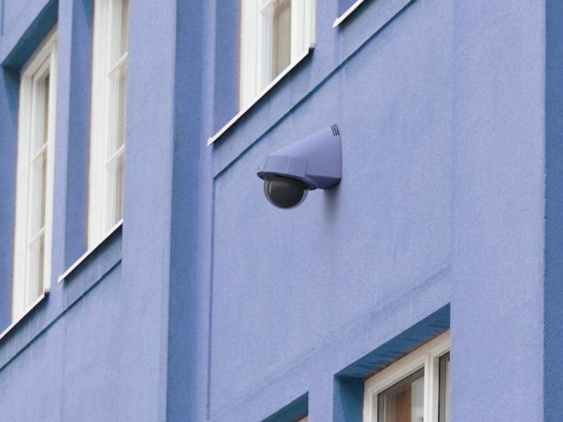 Axis IP Camera hanging on a blue building 