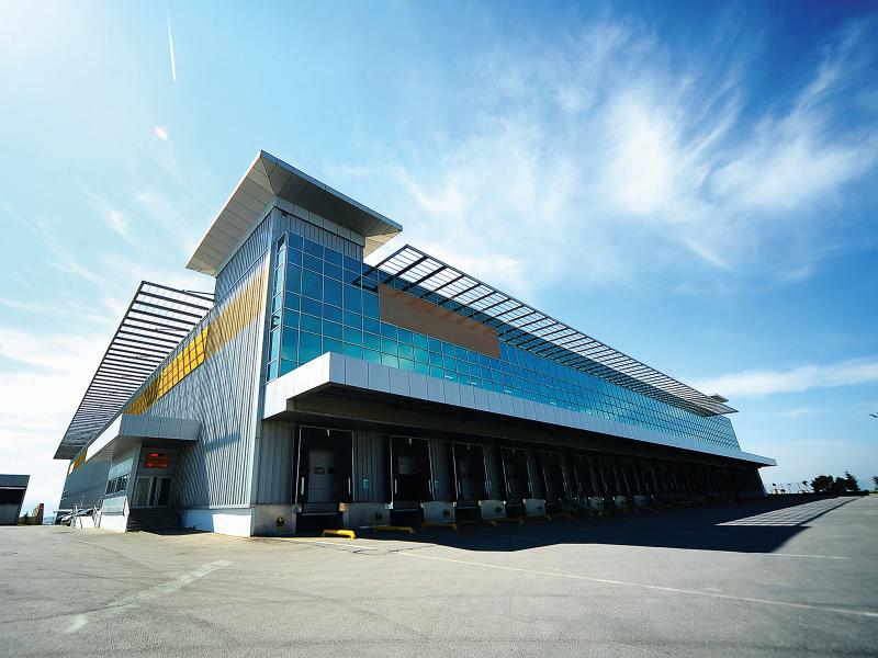 A building with a glass facade and loading docks.