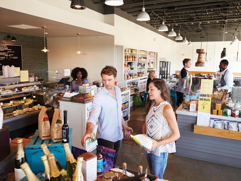 A couple shopping for groceries in a deli