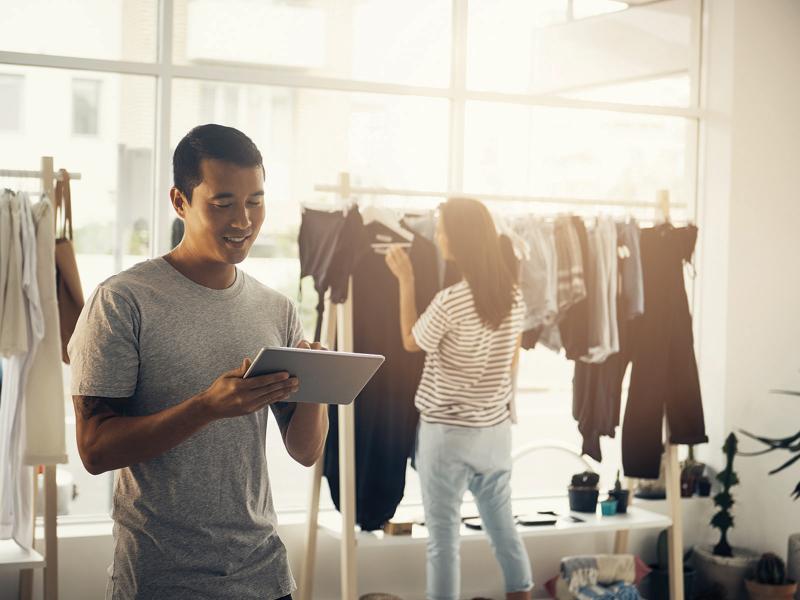 Man with a tablet standing in a retail store