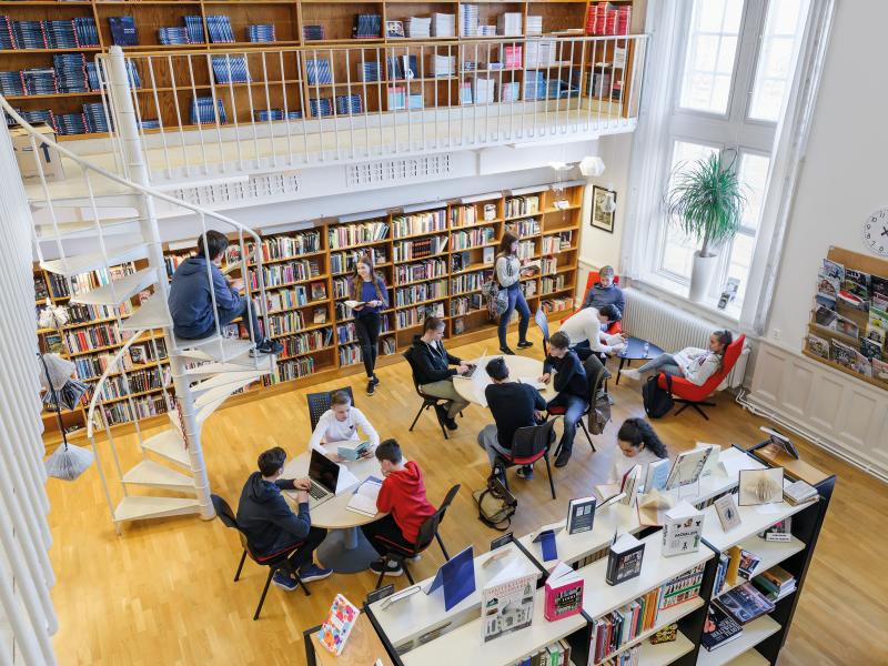 An overview of some kids sitting in a school library