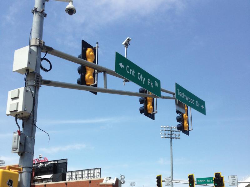 Axis pole camera on a street sign and traffic light.