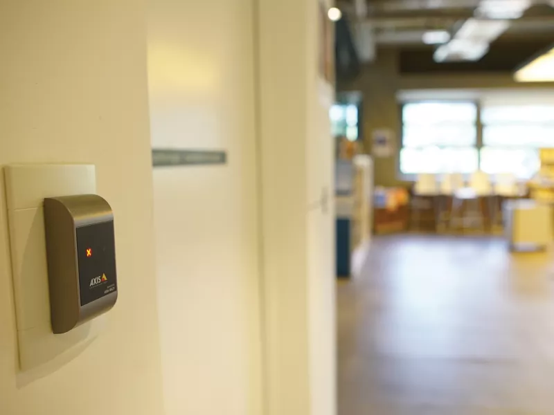 Axis A4010-E reader placed on white wall.
