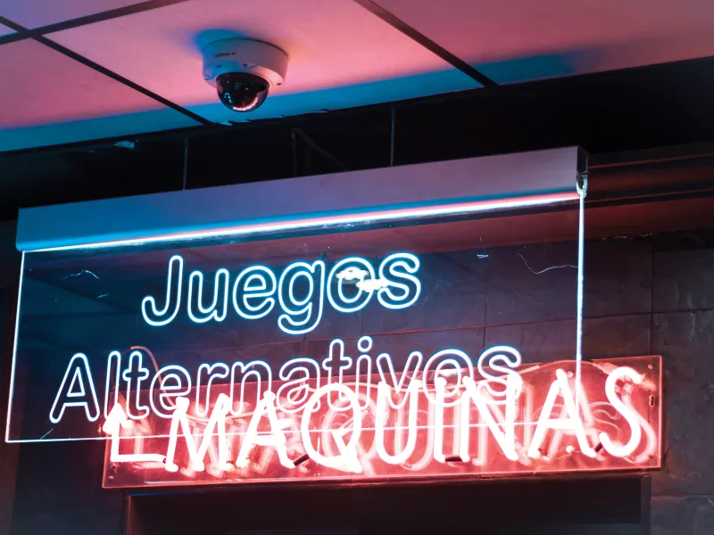 Axis camera in ceiling above illuminated signs.