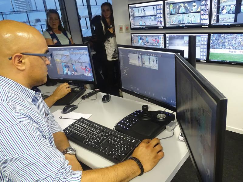 Man in front of monitors of Cenetario stadium.