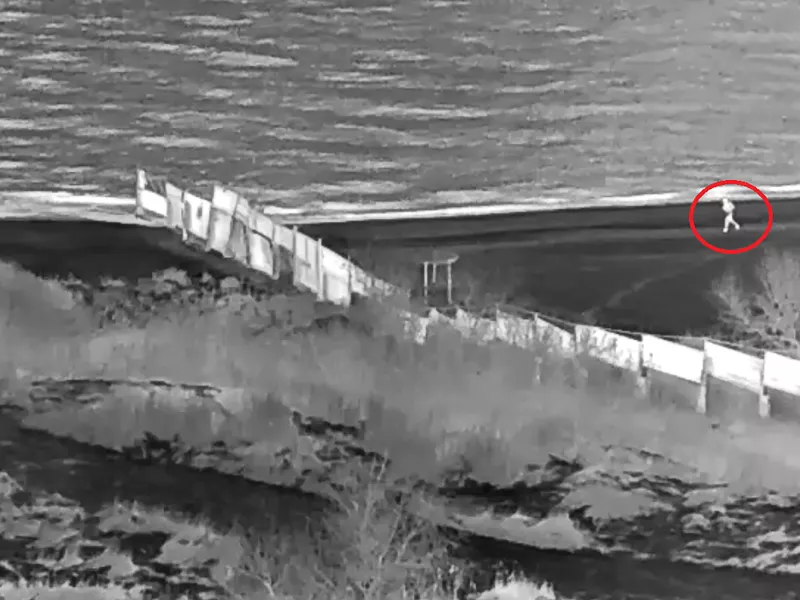 Screenshot of man at the beach, noticed by thermal camera and circled with red.
