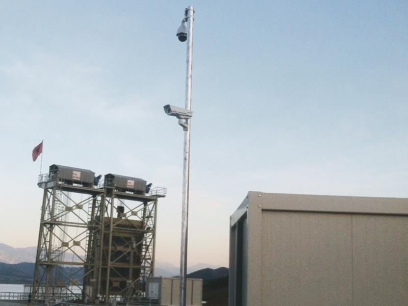 Outdoor pole with two cameras, at hydropower plant.
