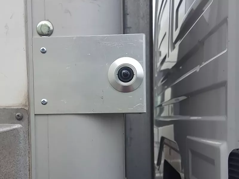 Small camera with metallic surrounding.