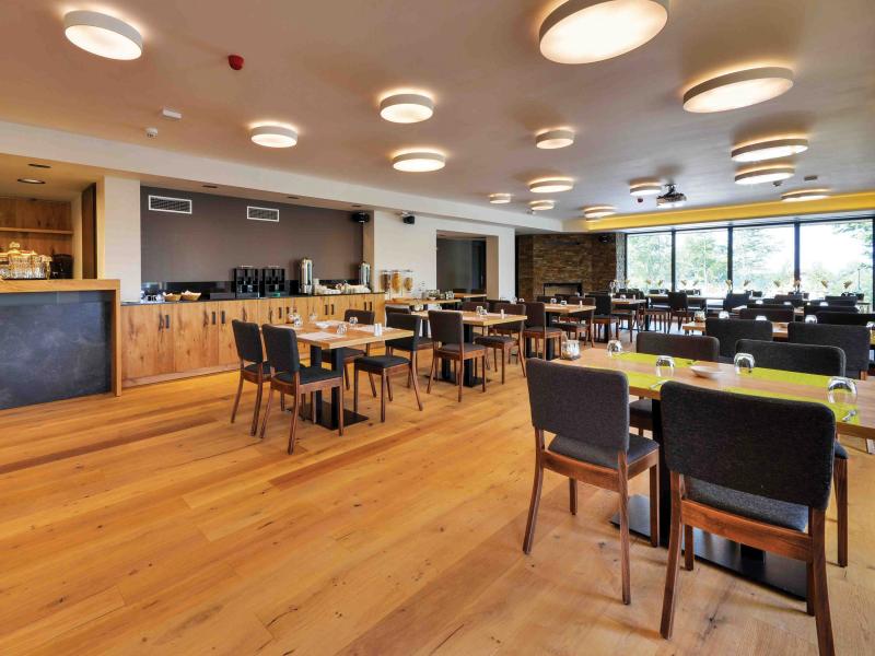 Empty hotel restaurants, wooden interior and black chairs.