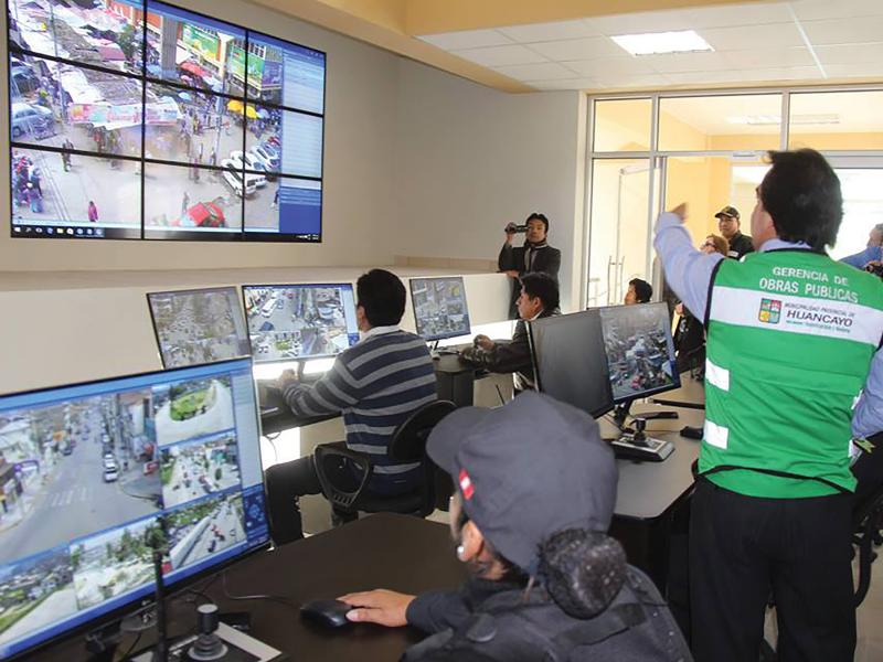 Monitor room, man in green shirt pointing.