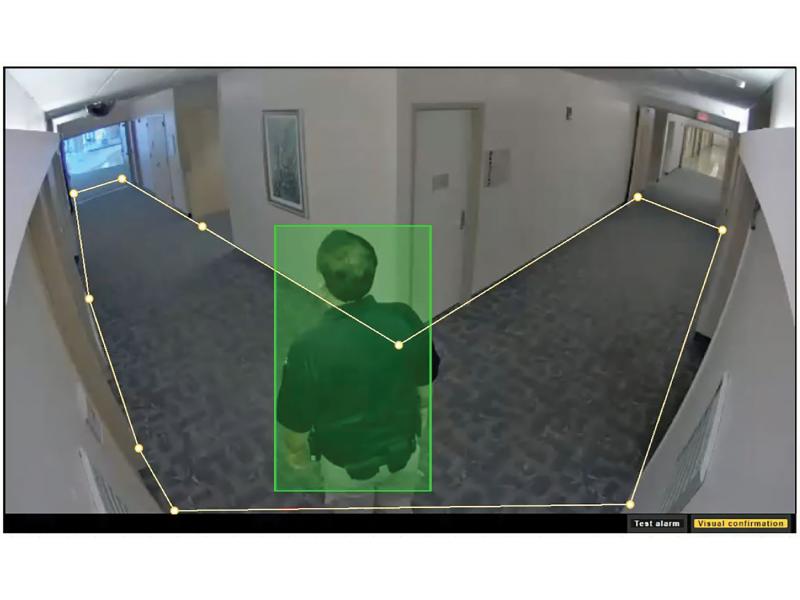 Axis loitering detection viewing a man in corridor, man marked green.