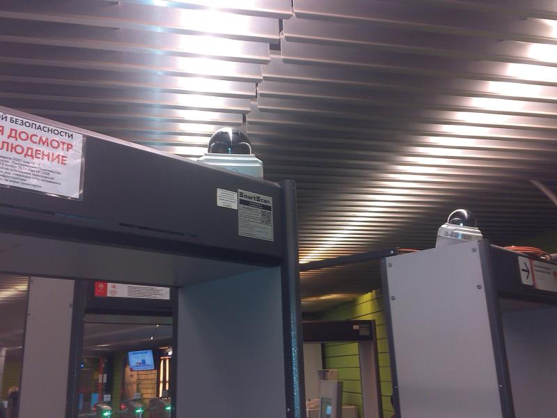 Axis cameras by metro gates, viewed from below.
