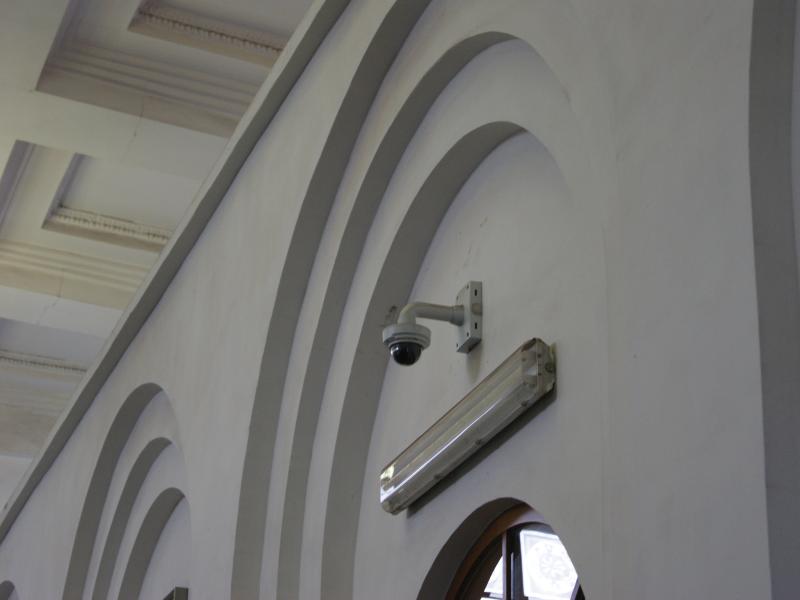 Axis P3384-V on white carved wall, viewed from its left angle.
