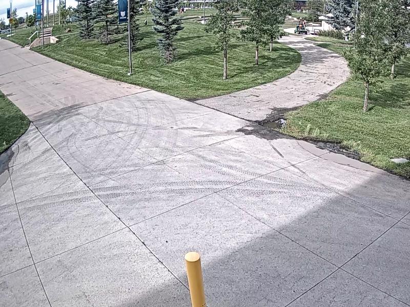 Camera view of sidewalk intersection.