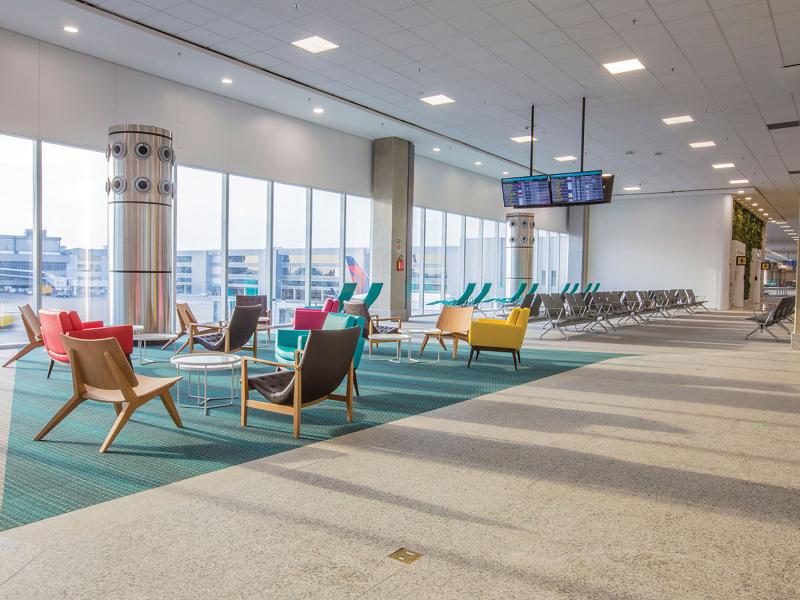 Gate waiting area, gate sign and colorful chairs.