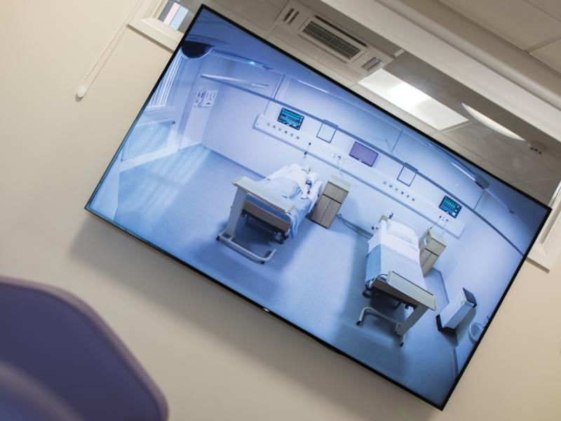 Monitor screen of two beds in clinic room, tilted view.